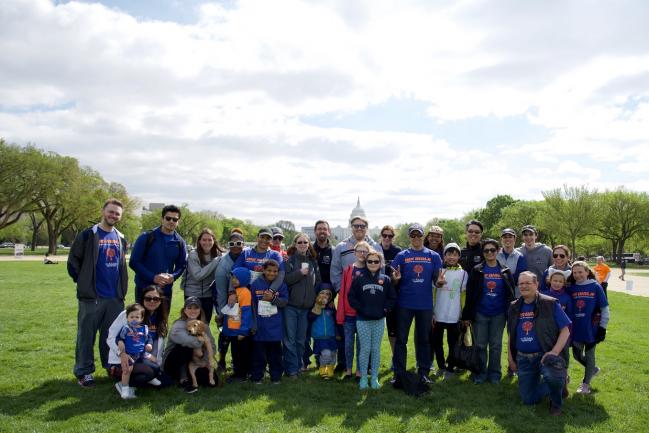 A group of MS Patient Education Day participants stand together with the U.S. Capitol Building in the background